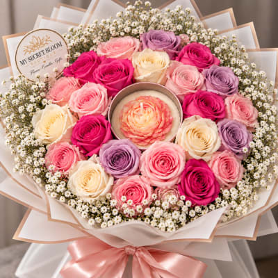 Bouquet of pink, cream, and lavender roses around a flower-shaped candle