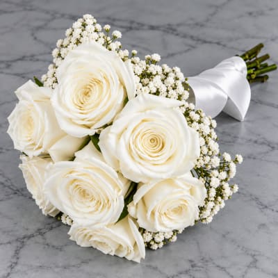 Bouquet of white roses with baby's breath and a white ribbon wrap