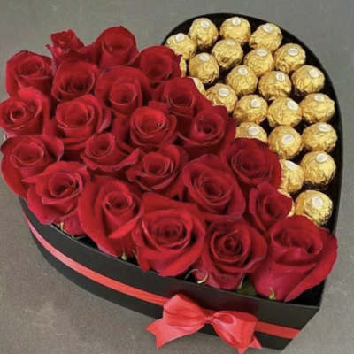 Heart-shaped box of red roses and gold-wrapped chocolates