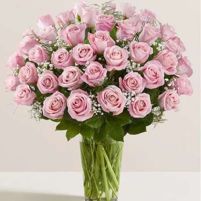 Pink roses arranged in a clear glass vase