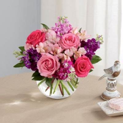 Pink and purple mixed bouquet in a clear glass vase