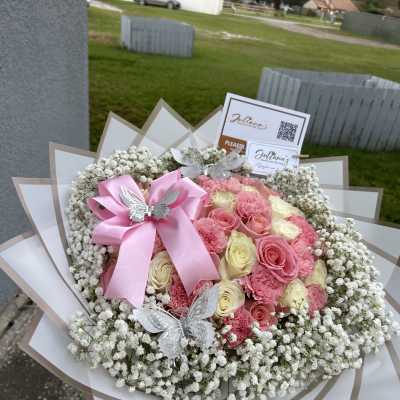 Pink and cream rose bouquet with baby’s breath and a pink ribbon