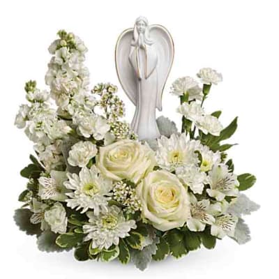 White floral arrangement with an angel figurine centerpiece