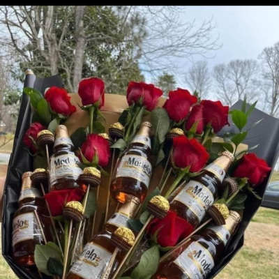 Bouquet of red roses with mini beer bottles and chocolate candies