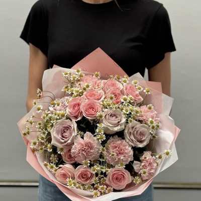 Pink rose bouquet with small white daisies wrapped in pink paper