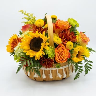 Basket arrangement with sunflowers, orange roses, and chrysanthemums