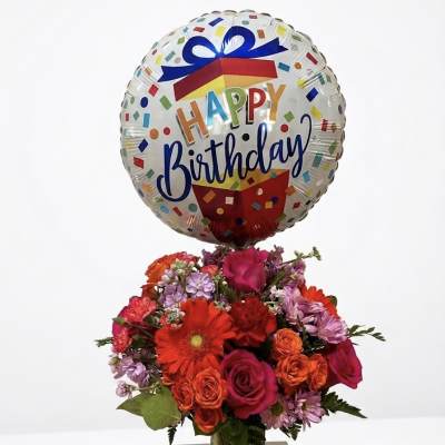 Birthday balloon above a colorful bouquet in a glass vase