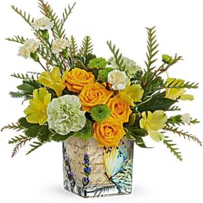Yellow roses and carnations in a decorative glass vase