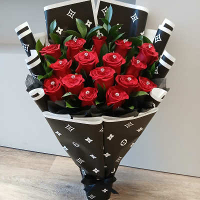 Bouquet of red roses wrapped in black patterned paper