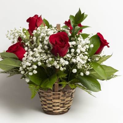 Red roses with white baby's breath in a woven basket