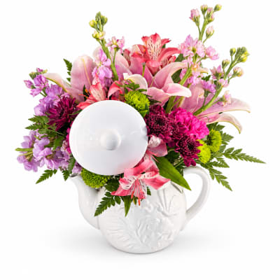 Pink and purple mixed bouquet in a white ceramic teapot