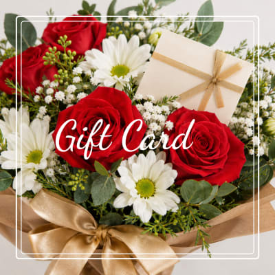 Gift card over a bouquet of red roses and white daisies