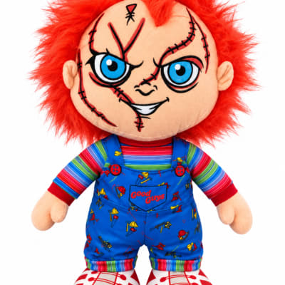 Plush doll with red hair and blue overalls on a white background