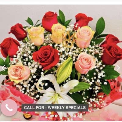 Bouquet of red and blush roses with white lilies and baby's breath