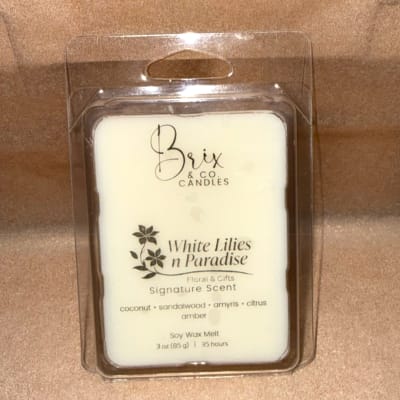 Packaged white wax melt in a clear plastic clamshell