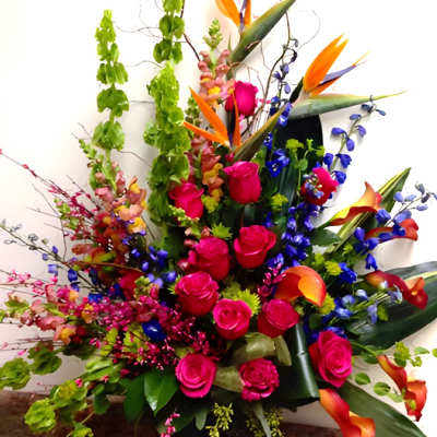 Bright tropical bouquet with pink roses and orange bird-of-paradise flowers