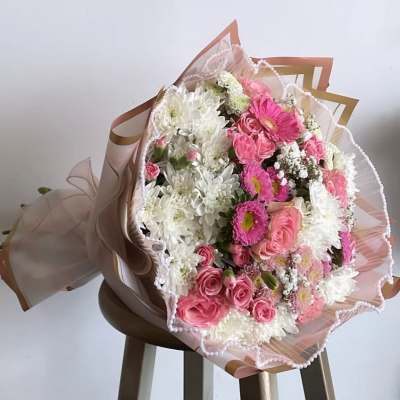 Pink and white mixed bouquet wrapped in decorative paper