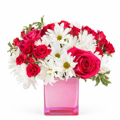 Pink roses and white daisies in a pink glass vase