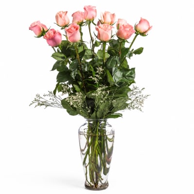 Pink roses arranged in a clear glass vase