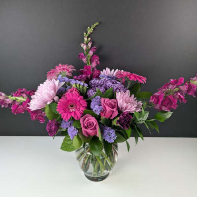 Pink and purple mixed bouquet in a clear glass vase