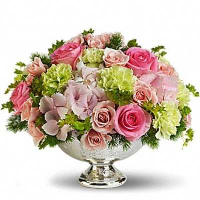 Pink and blush roses with green carnations in a silver pedestal bowl