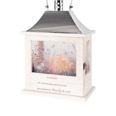 White memorial lantern with floral artwork and a metal handle