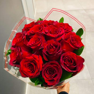 Bouquet of red roses wrapped in clear plastic