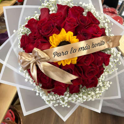 Bouquet of red roses with a yellow sunflower and white baby's breath