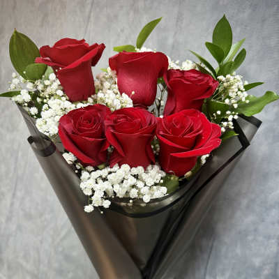 Bouquet of red roses with white baby's breath in black wrap