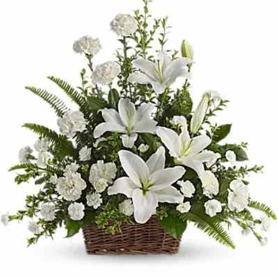 White lilies and carnations in a wicker basket