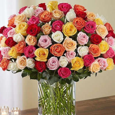 Large bouquet of multicolored roses in a clear glass vase