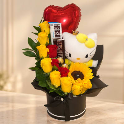 Yellow roses and a sunflower with a Hello Kitty plush, chocolates, and a red heart balloon