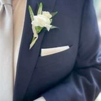 White boutonniere on a navy suit jacket