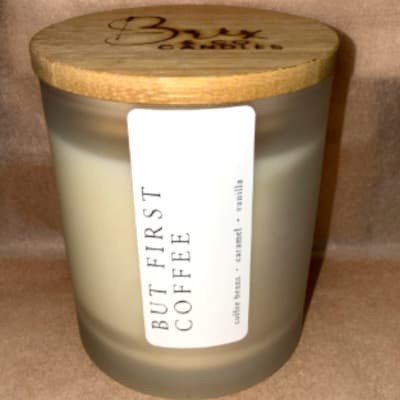 Frosted glass candle jar with a wooden lid and label