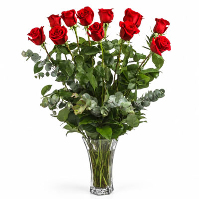 Red roses arranged in a clear glass vase