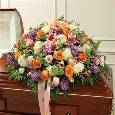 Large floral casket spray with pink, orange, white, and purple blooms