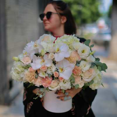 Large bouquet of white and blush flowers in a white vase