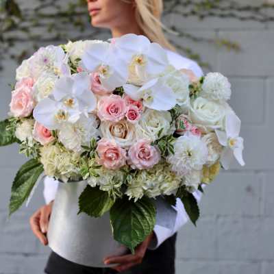 Large bouquet of white orchids, pink roses, and white hydrangeas