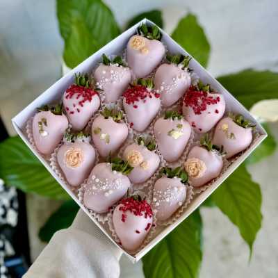 Box of pink chocolate-covered strawberries with decorative toppings