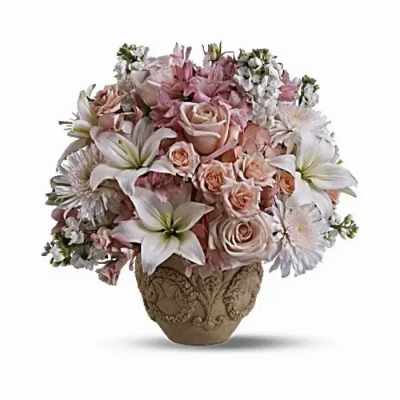 Pink and white floral arrangement in an ornate vase