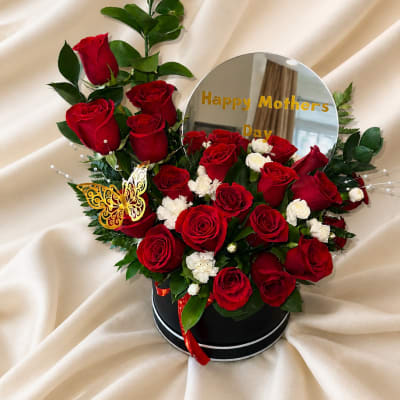Beautiful design with mirror, Happy Mother's Day phrase, natural roses, carnations, and golden butterfly