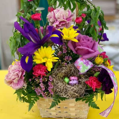 Colorful flower basket with butterflies and a bird nest centerpiece