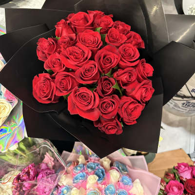 Bouquet of red roses wrapped in black paper
