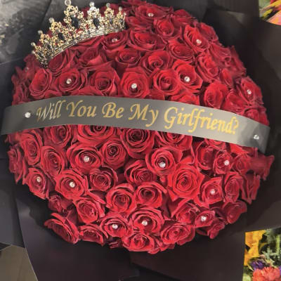 Red rose bouquet with a tiara and "Will You Be My Girlfriend?" ribbon