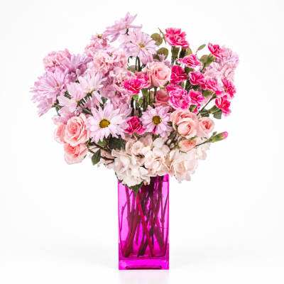Pink mixed bouquet in a tall magenta vase