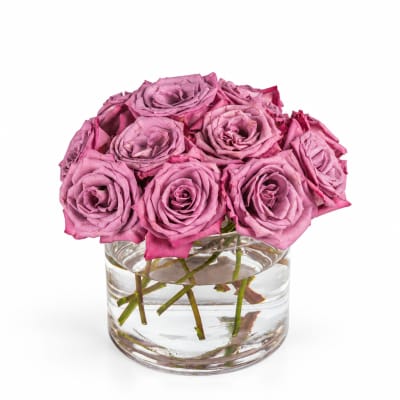 Pink roses arranged in a clear glass vase