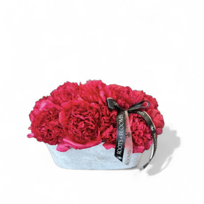 Hot pink flower arrangement in a silver box with ribbon