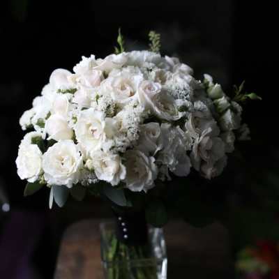 White rose bouquet in a clear glass vase