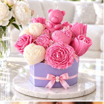 Pink and cream flower-shaped candles in a lavender gift box with a teddy bear candle