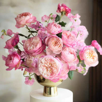 Pink roses arranged in a gold vase